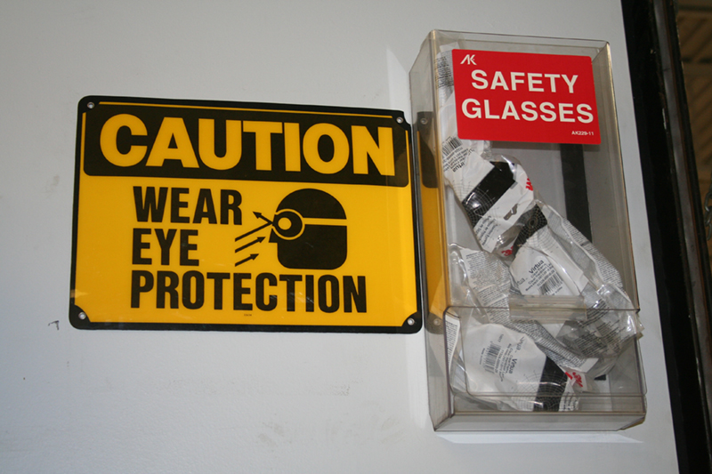 Many shops post signs reminding workers and visitors to wear eye protection. Some shops have safety glasses available. OSHA and local regulations require safety procedures.