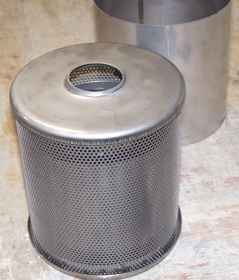 A stainless steel cylinder forms the substrate around which the woven ceramic material is wrapped, providing excellent strength, durability, and noise attenuation.