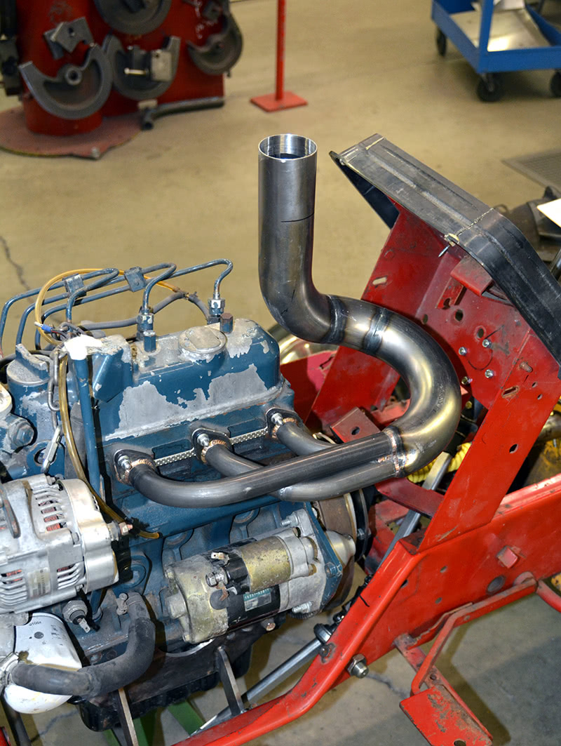 We were wandering around the shop, upsetting the work flow (again), and talking to the crew when we spotted this little project. We don’t know a thing about these little tractor pullers, but we’re going to have to go and check it out this summer. Look at that header design! It’s a thing of beauty. three-cylinder-diesel-puller-header
