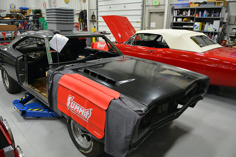 One of the things that your preliminary inspection does is determine if there are body panel fit problems. If you spot gradually widening or diminishing body gaps, you have to chase down the cause before you start disassembly. Otherwise, you might re-introduce the defect as the car is built back up. The only stable dimension is usually the firewall, and everything builds fore and aft from there. Here, a new reproduction hood is fitted to the existing hood opening to see how the gaps from hood-to-fender and hood-to-cowl filler align. If there’s a problem, you should plan your fix now -- if it’s good now, it’ll be good later. There’s nothing worse than trying to muscle freshly-painted parts into position to adjust away a problem that should have been identified at the start of build. new panels are test fit before the surrounding sheet metal is removed