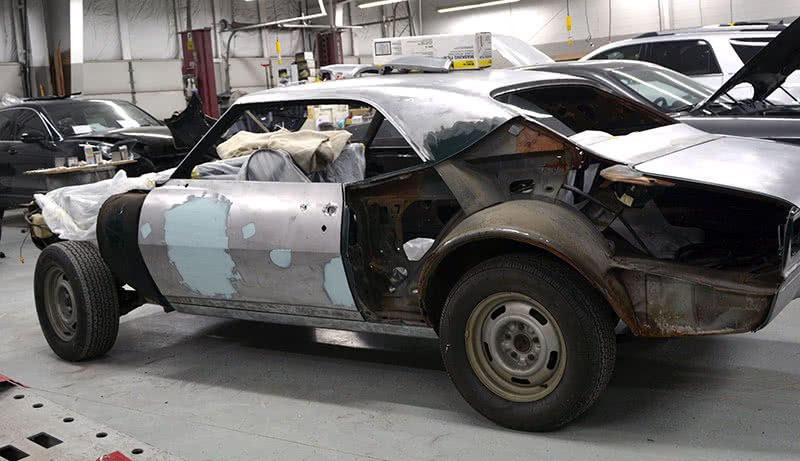 Right:Here’s what Project ‘68 Camaro looked like part way through the process. The door has been partially repaired and we’ve hung it again in preparation for installing the rear quarter panel. The firewall is the starting point -- align the door to the firewall -- then the quarter to the door. Build from the firewall forward and the firewall aft. There’s a lot of pre-fitting, double-checking and prep work to do before the panel is welded on, but you can see what the thought process is. the firewall is the main datum line to build from panels must align from that point